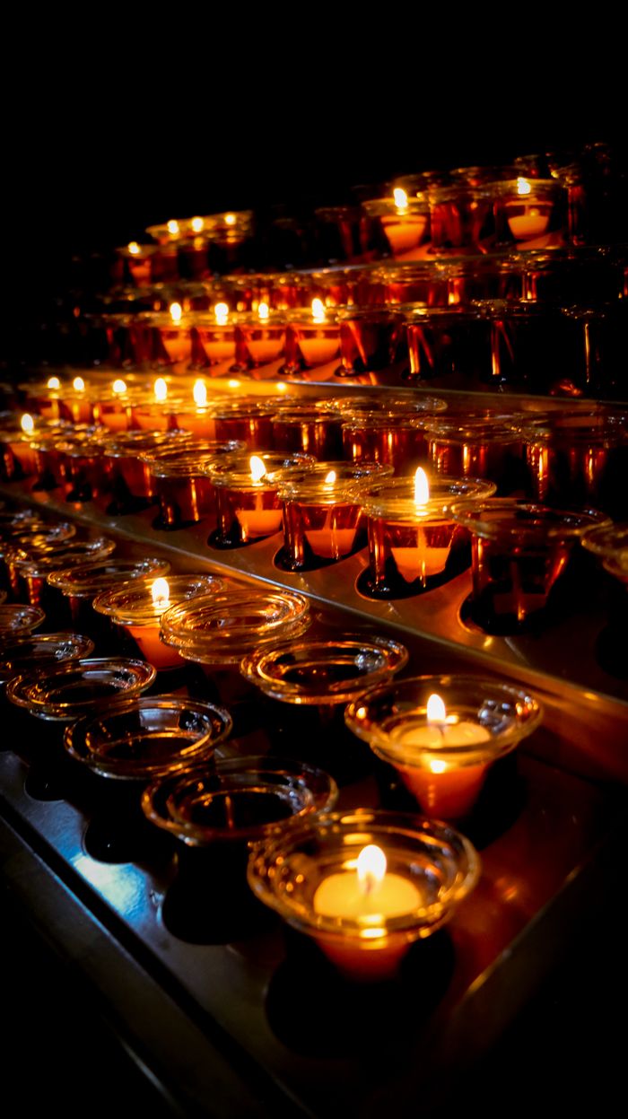 Soft candlelight illuminates the dark with warm, flickering flames creating a serene ambiance.